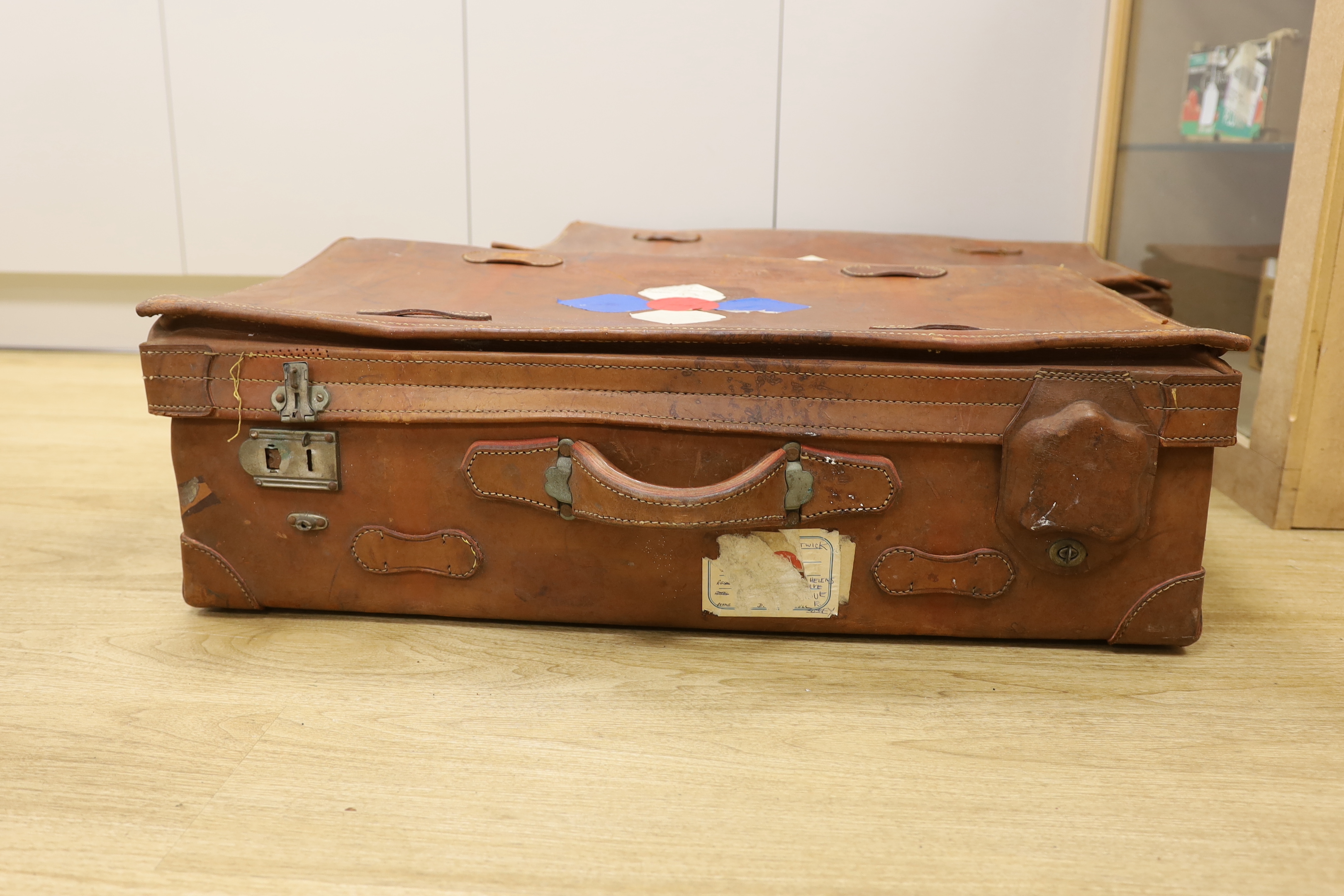 A pair of large brown leather suitcases, 81cm wide, 47cm deep